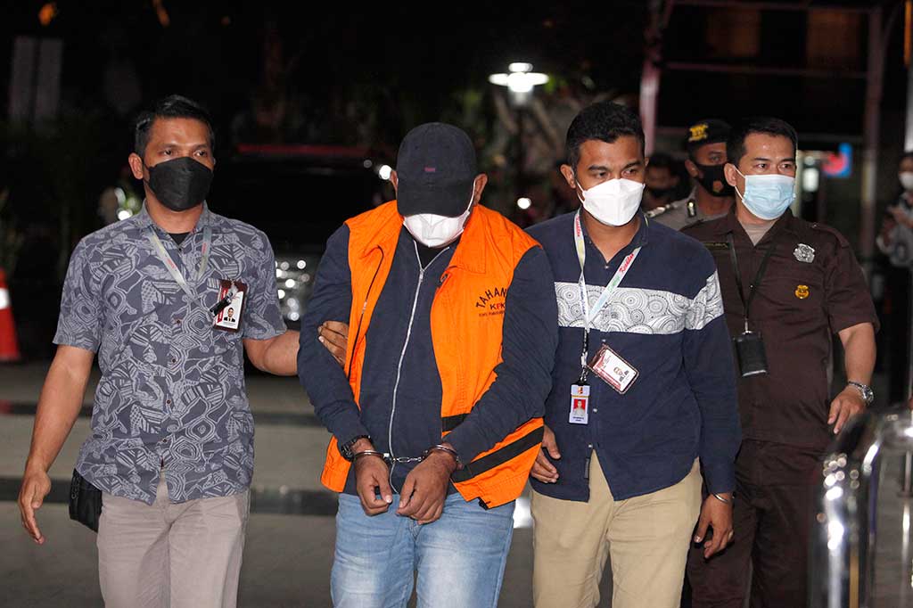 Izil Azhar tiba di Kantor KPK pada pukul 19.43 WIB dengan tangan terborgol dan menggunakan rompi oranye bertuliskan Tahanan KPK.