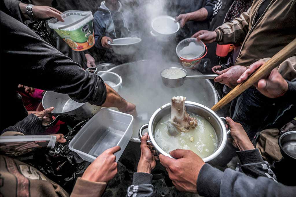 Sebelum masakannya matang, puluhan anak telah mengantre dengan membawa panci, rantang, dan wadah untuk mendapatkan sup yang lezat tersebut.