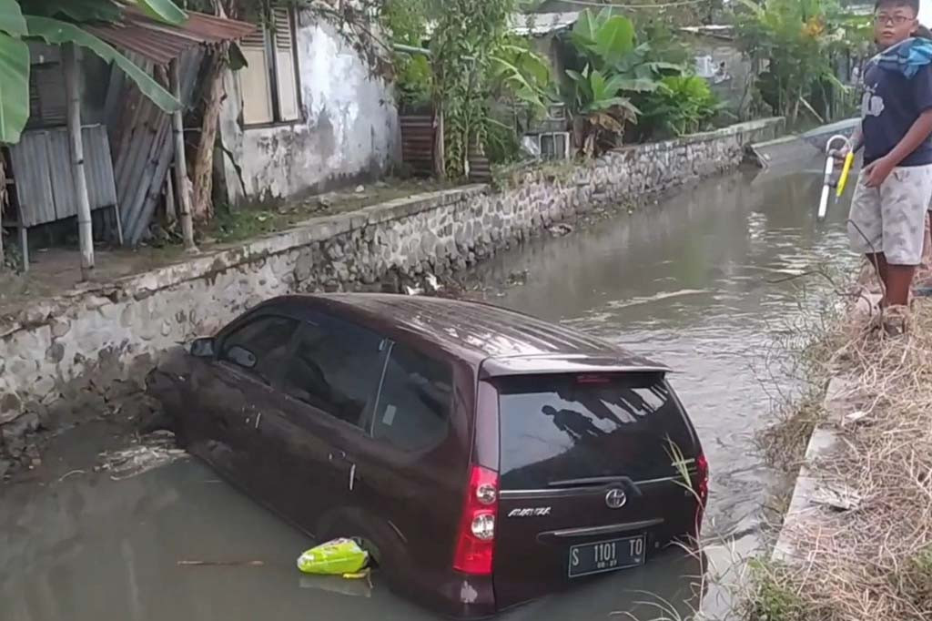 Karena truk kemudian mendahului sebuah kendaraan lain yang ada didepan dengan sedikit memakan lajur. Sopir minibus lantas terkaget dan langsung memilih banting setir ke kiri hingga meluncur ke dalam sungai dan tercebur.