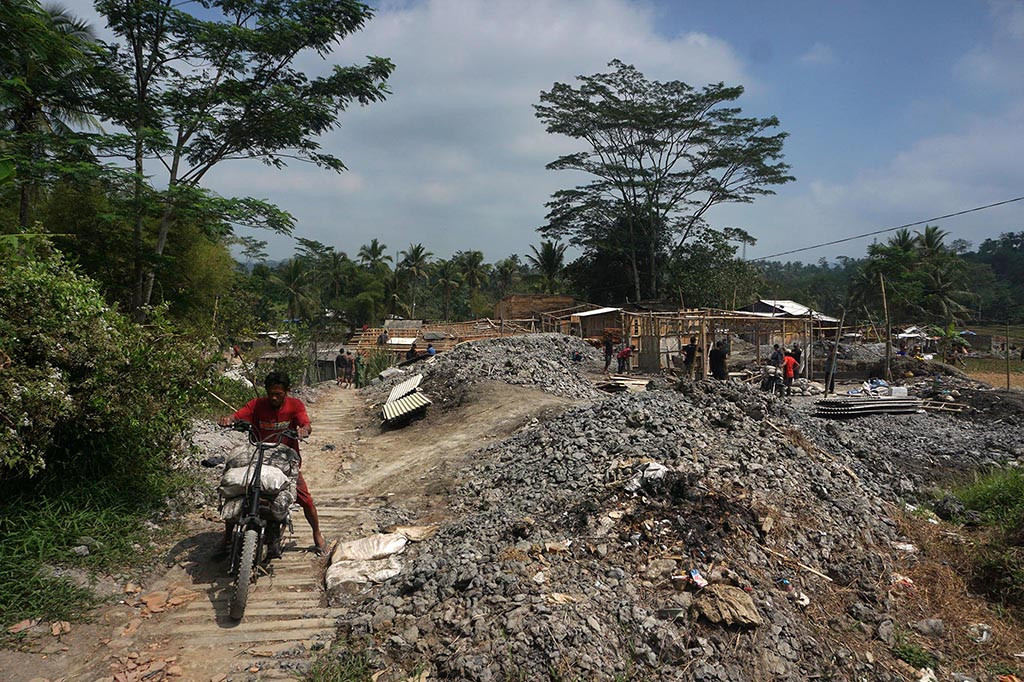 Ratusan penambang membongkar lapak tambang emas milik mereka sendiri di Dusun Tajur, Desa Pancurendang, Kecamatan Ajibarang, Kabupaten Banyumas, Jawa Tengah, Selasa, 8 Agustus 2023. Mereka terlihat membawa sisa-sisa hasil tambang serta membawa kayu-kayu yang sebelumnya untuk lapak tambang.
