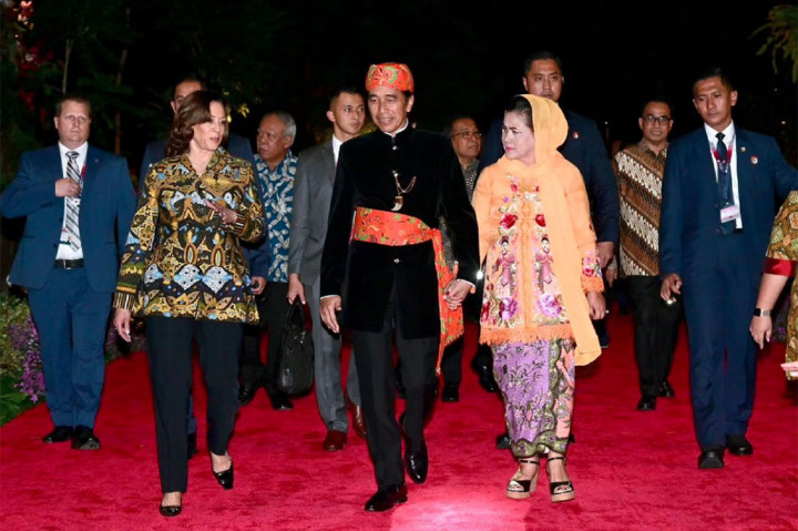 Jokowi mengenakan pakaian bangsawan ujung serong berwarna hitam, dilengkapi aksesoris kopiah berwarna oranye, serta selendang berwarna serupa yang disematkan di pinggang. Sementara itu, Ibu Negara mengenakan kebaya encim berwarna kuning cerah, dengan motif kembang bernuansa merah jambu, serta kain Betawi dengan warna serupa. Selendang kuning bermotif polos menutupi bagian kepala Iriana.