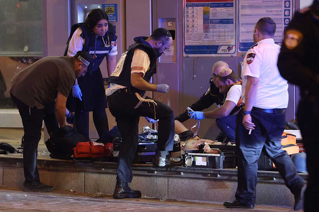 Paramedis Israel memeriksa seorang pria yang diduga penyerang, di lokasi serangan penikaman yang dilaporkan di sebuah stasiun kereta api di Yerusalem pada Kamis, 21 September 2023.