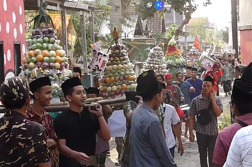 Masyarakat yang menyaksikan pun, tampak antusias. Mereka juga menanti buah dan sayur yang dikirab akan dibagikan ke warga.