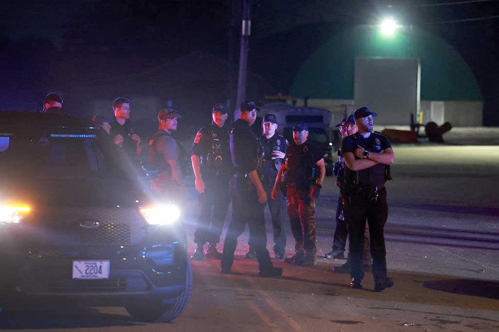 Polisi berjaga-jaga di dekat area tempat Robert Card, tersangka penembakan massal, ditemukan tewas di Lewiston, Maine, AS, Jumat, 27 Oktober 2023 waktu setempat. Mr Card, yang diduga membunuh 18 orang dalam penembakan massal di arena bowling dan restoran di Lewiston, ditemukan tewas di dekat Lisbon.