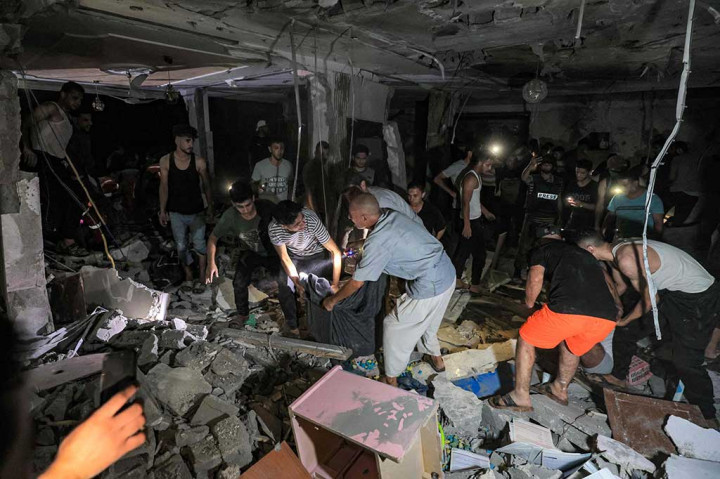 Tim penyelamat dan orang-orang melakukan evakuasi terhadap para korban di rumah jurnalis TV Palestina Mohammed Abu Hatab, yang terbunuh bersama anggota keluarganya selama pemboman Israel di Khan Yunis, Jalur Gaza, Kamis, 2 November 2023 waktu semtepat.