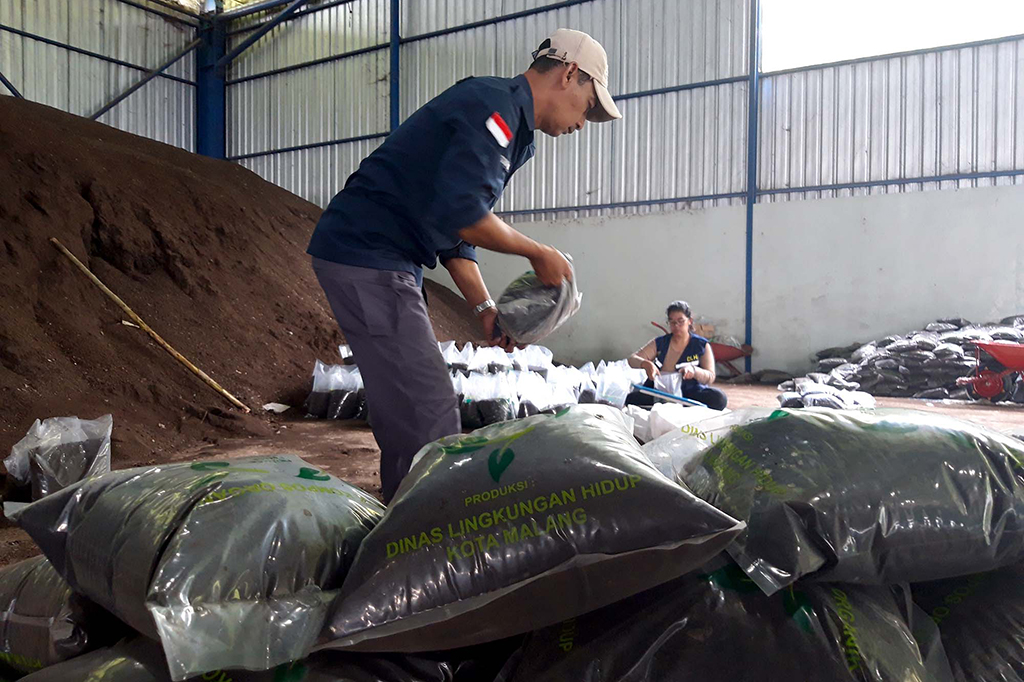 Di gedung komposting ia tak sendiri. Melainkan bersama 13 rekan kerja. Mereka di antaranya Dwi, Dafa, Yusril, Dimas, Fauzi, Yoga, Faktur, Muklas dan Wahyu. Tugas masing-masing mulai pemilahan, pengolahan,
operator alat berat sampai pengemasan. Pegawai lainnya merawat peralatan dan mesin pengolah kompos. Seluruh proses produksi di tempat itu berteknologi modern. Saban hari, alat berat dan mesin bergerak bersama mempercepat proses produksi kompos.