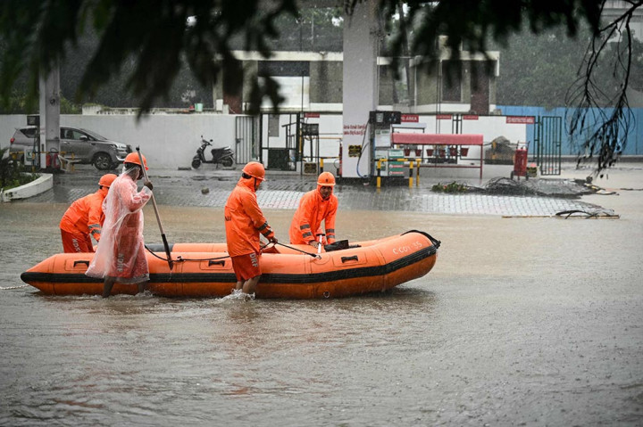 Di Chennai, mobil-mobil terlihat terapung di arus deras, rumah-rumah terendam banjir, dan seekor buaya terlihat berenang di jalanan kota.