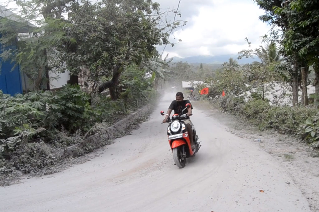 Saat ini kondisi jalan utama di Desa Hokeng Jaya tertutup abu vulkanik namun kendaraan masih bisa lewat, itupun laju kendaraan diperlambat.