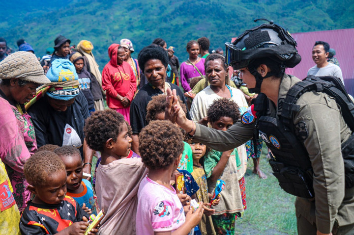 Sosok Polwan Ops Damai Cartenz-2024, Brigpol Ita Sombo Allo, terlihat aktif berbagi kasih dengan anak-anak Distrik Kiwirok, yang didampingi dengan antusias orang tua mereka.