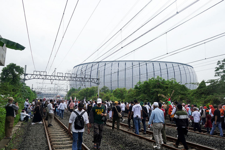 Masyarakat datang dari arah Stasiun Ancol membuat penumpukan di pintu barat. Commuter Line yang melintas pun harus berjalan pelan karena masyarakat yang berjalan di atas rel. Samping rel merupakan salah satu akses dari Stasiun Ancol menuju JIS.