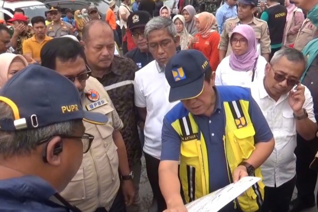 Dengan menaiki perahu karet PJ Gubernur ingin melihat langsung titik jebolnya tanggul yang mengakibatkan banjir.