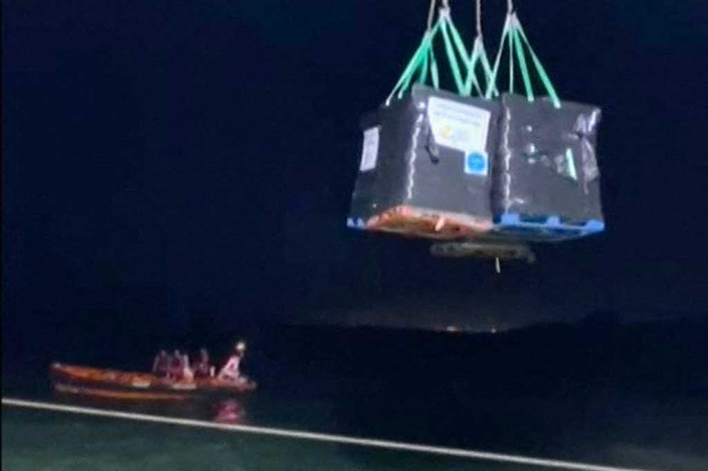 Anggota badan amal AS menurunkan bantuan makanan untuk Jalur Gaza dari kapal Open Arms, ke pantai wilayah Palestina yang terkepung pada Kamis, 15 Maret 2024, di tengah pertempuran yang sedang berlangsung antara Israel dan kelompok militan Hamas.