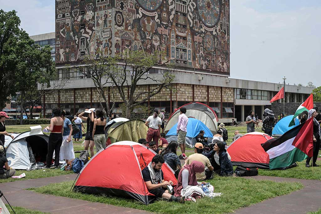 Mengibarkan bendera dan meneriakkan “Hidup Palestina Merdeka”, para pengunjuk rasa mendirikan tenda di depan kantor pusat Universitas Otonomi Nasional Meksiko (UNAM) di Mexico City, Kamis, 2 Mei 2024.