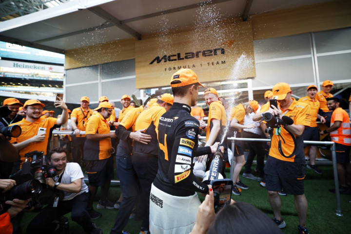 Norris diangkat ke udara oleh mekanik McLaren saat penantian panjangnya untuk meraih kemenangan dalam olahraga tersebut telah berakhir. 