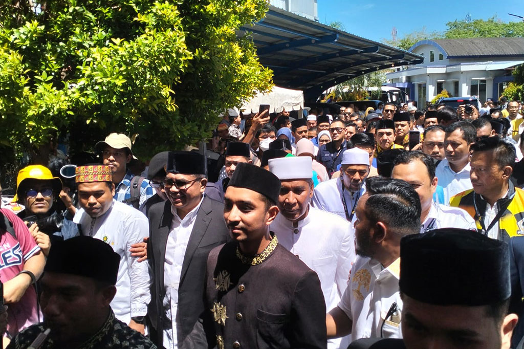 Bustami dan Tu Sop tiba di Kantor KIP Aceh sekitar pukul 11:00 WIB. Sebelum masuk ke kantor, keduanya menjalani ritual peseujuk (tepung tawar), sebuah tradisi Aceh untuk memohon keselamatan dan kelancaran.