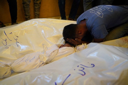 Seorang warga Palestina berduka atas kematian anggota keluarganya, yang tewas dalam serangan Israel di rumah mereka, di Khan Yunis di Jalur Gaza selatan.