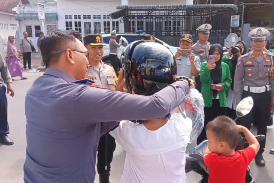 Pembagian helm kepada pengendara baik roda dua dan becak motor di Padang Sidimpuan langsung dibagikan kepada pengendara yang melintas di jalan.