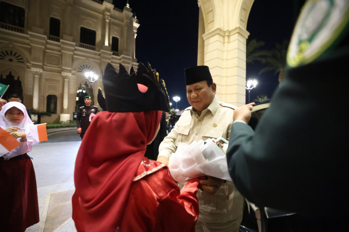 Dua siswa Sekolah Indonesia Jeddah menyerahkan bunga tangan kepada Presiden Prabowo. Presiden kemudian menyapa para pelajar satu per satu yang berbaris di sisi kanan dan kiri pintu utama hotel serta foto bersama dengan para siswa.