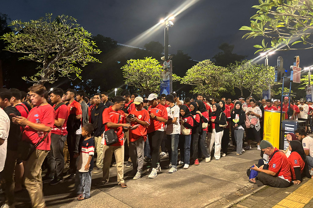 Ribuan pendukung mengantre sejak petang untuk memasuki stadion GBK. Para pendukung mayoritas mengenakan jersey serba merah antre berjajar rapi.