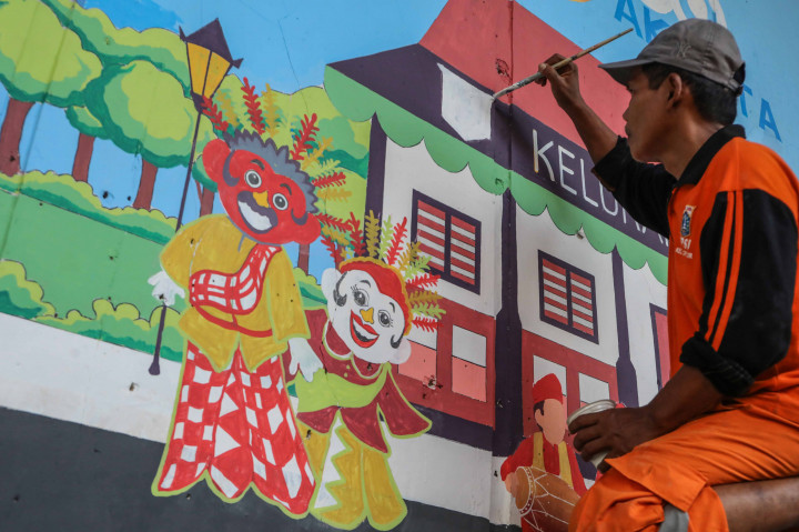 Petugas Penanganan Sarana dan Prasarana Umum (PPSU) Kelurahan Cipulir menghiasi dinding flyover Pasar Kebayoran, Jakarta Selatan, dengan mural penuh warna, Selasa, 2 September 2025.