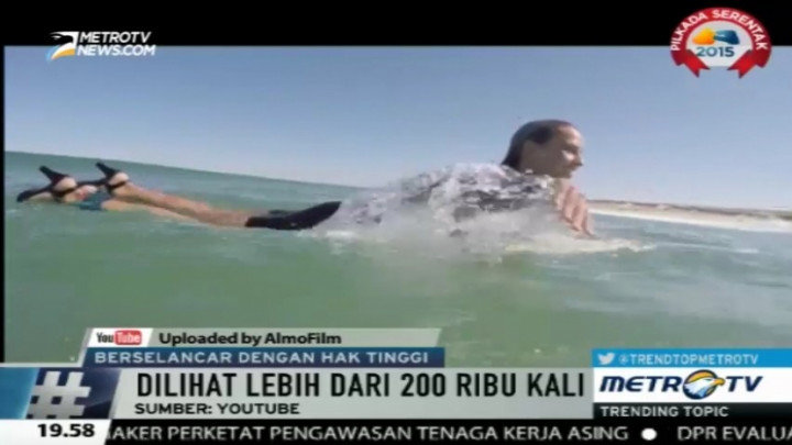 Wow, Wanita Ini Berselancar Menembus Ombak dengan Sepatu Hak Tinggi 