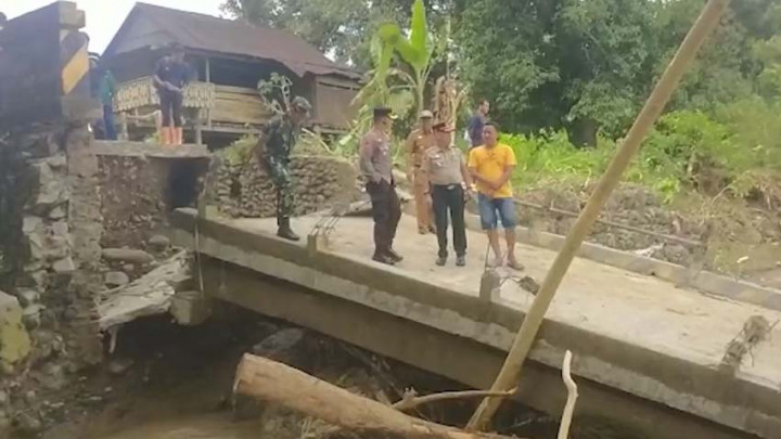 Warga Nekat Lewati Jembatan Miring Pasca Banjir di Desa Cemba